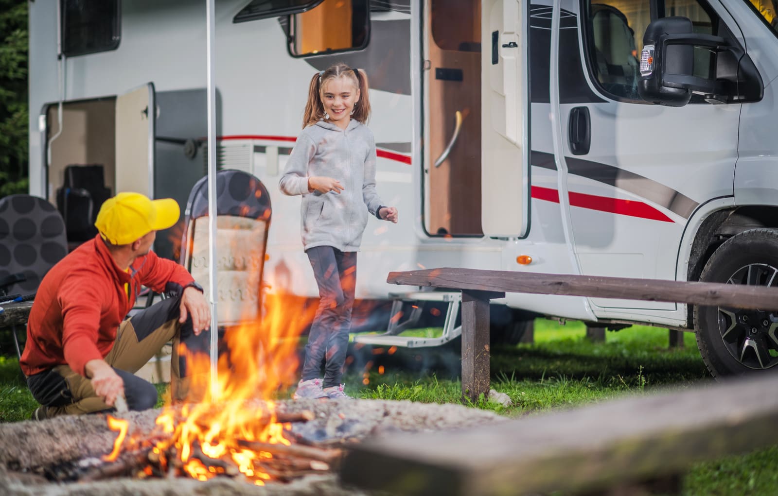A family at a campfire next to their motorhome